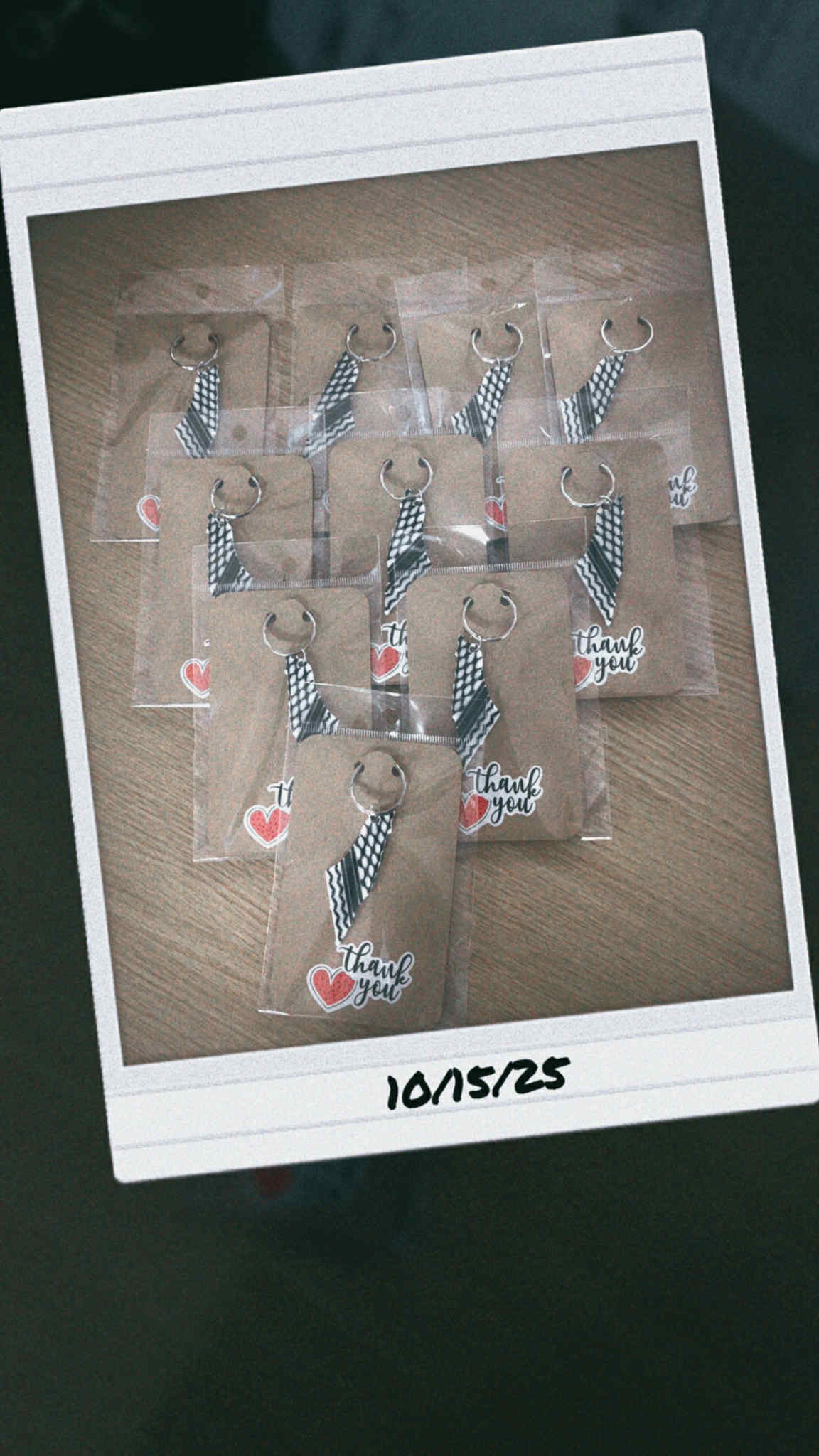 “Kuffiyeh pattern keychains packaged with thank you tags on wooden surface.”
“Set of Palestinian-inspired black and white woven fabric keyrings.”
“Cultural kuffiyeh keychain with metal loop symbolizing solidarity and heritage.”